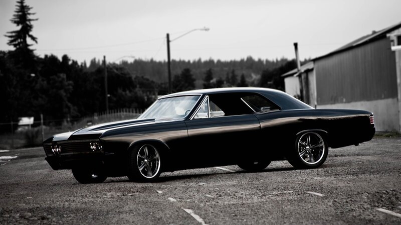 black classic car in parking lot