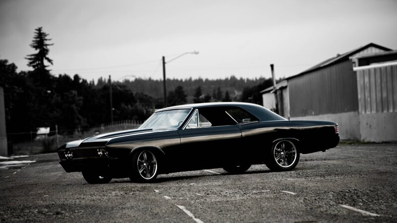 black classic car in parking lot