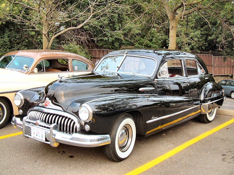 Black classic car in parking lot