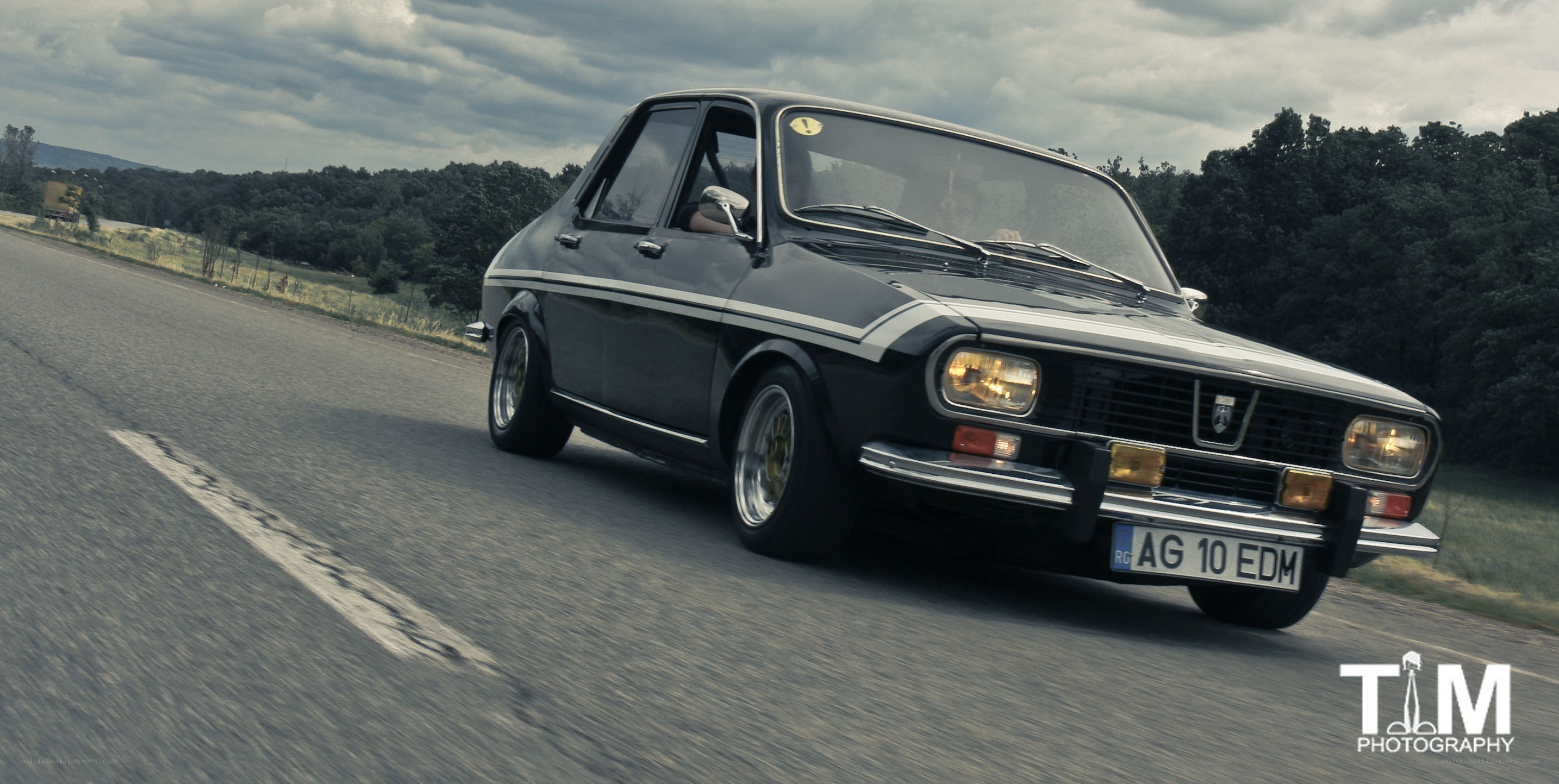 Black classic car on a road
