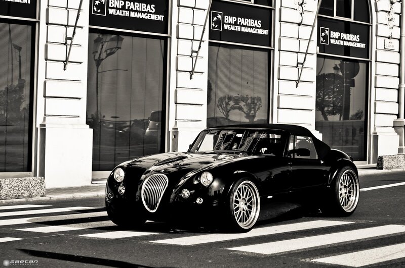 Black classic car on city street