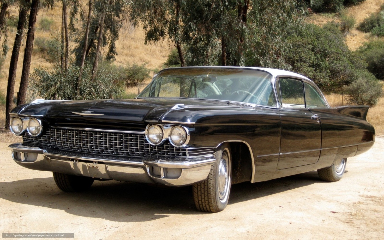 Black classic car on dirt road