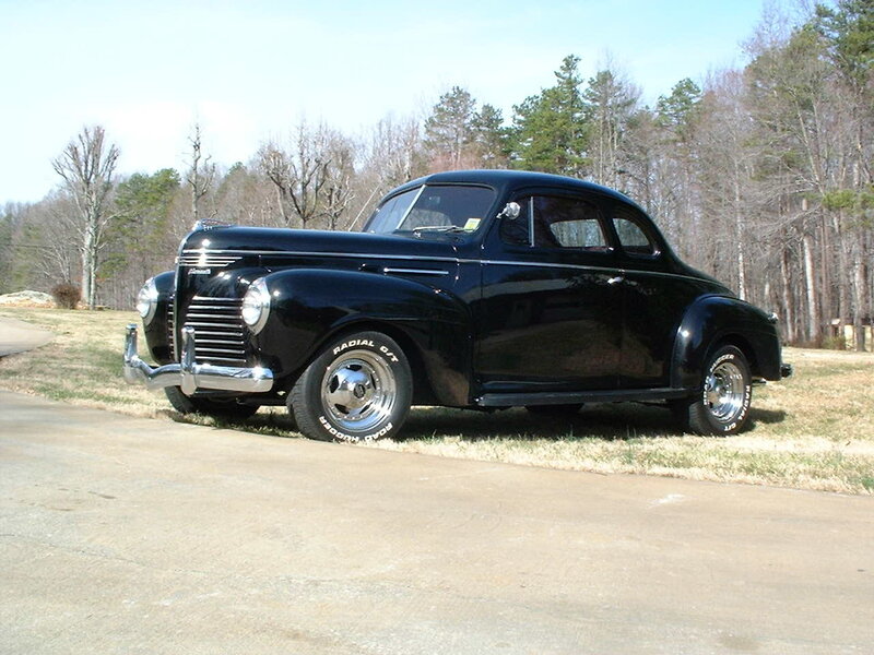 Black classic car on driveway