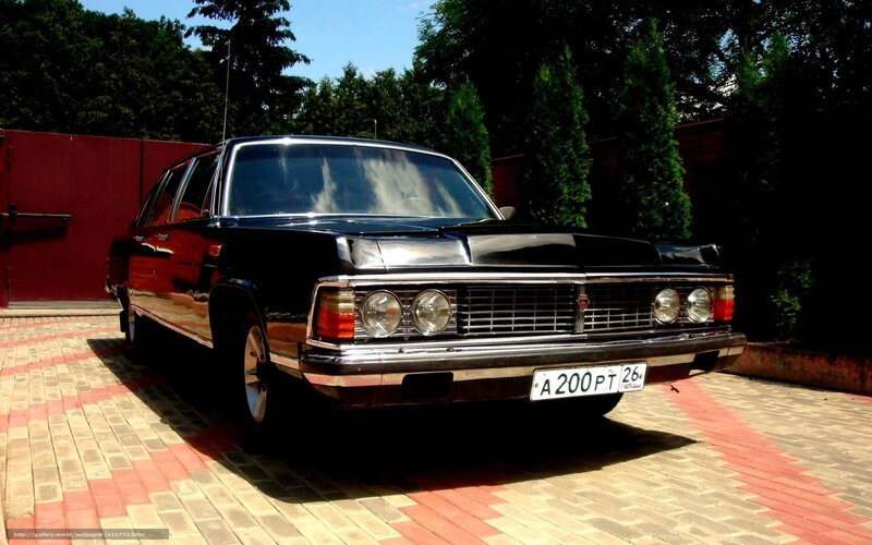 Black classic car on driveway