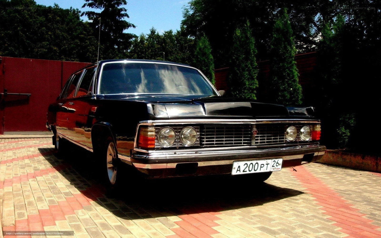 Black classic car on driveway