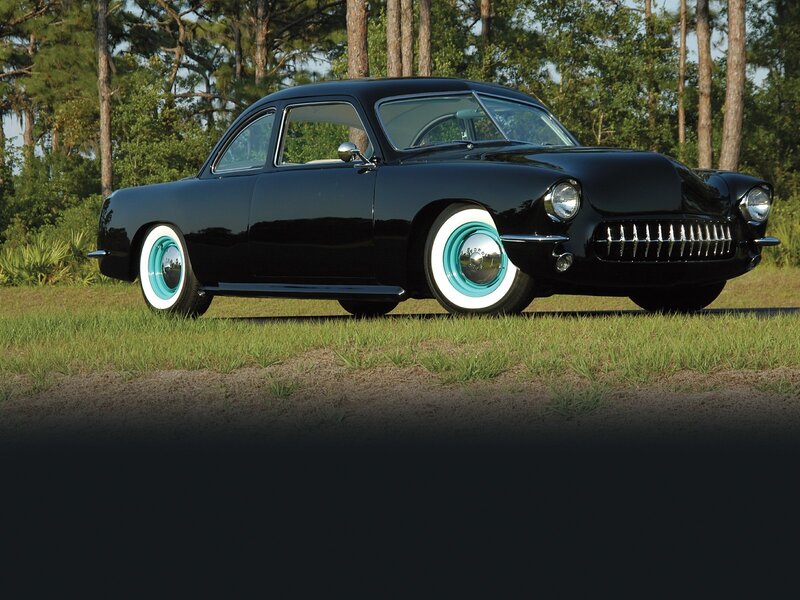 Black classic car on grass