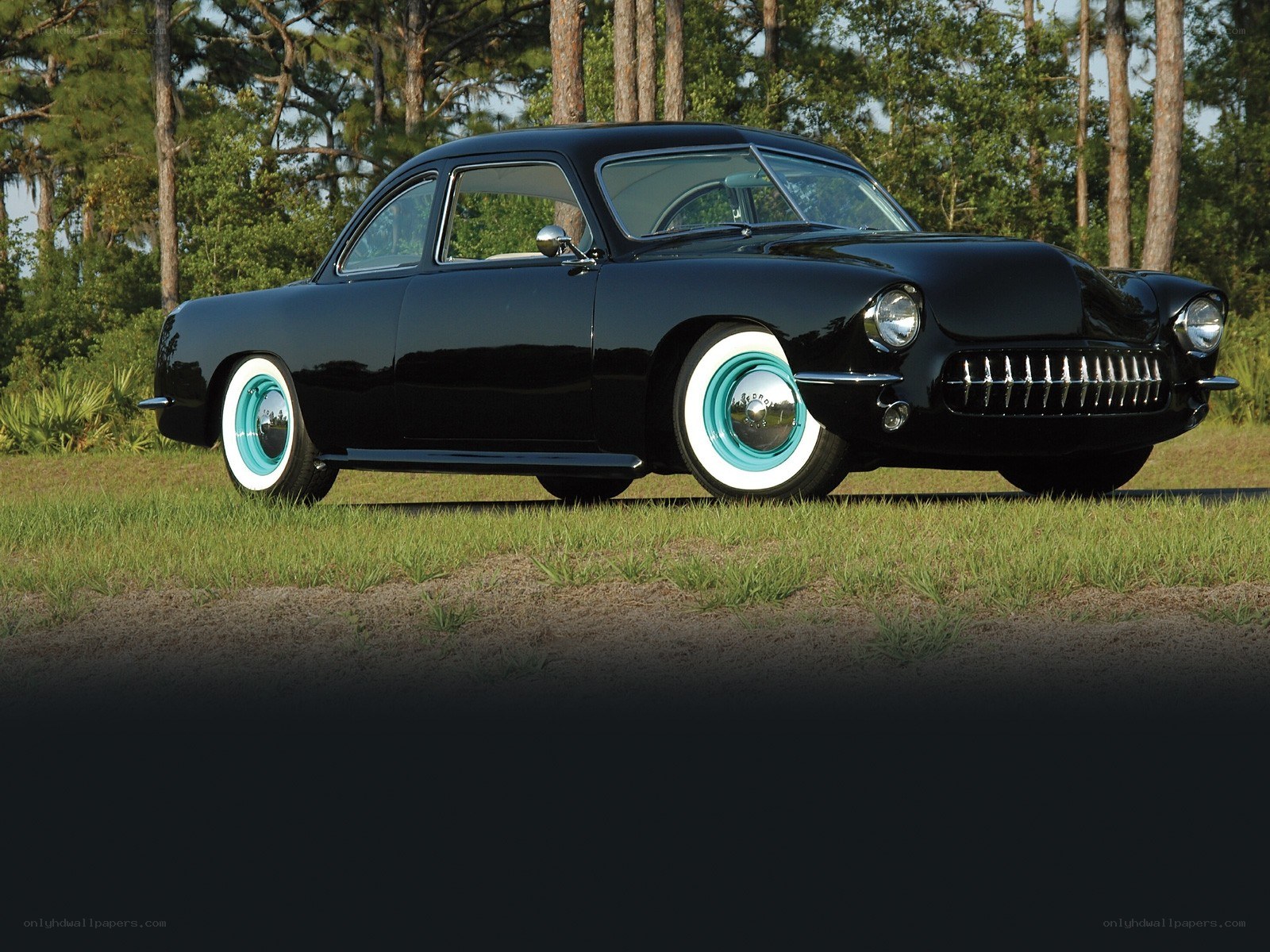 Black classic car on grass