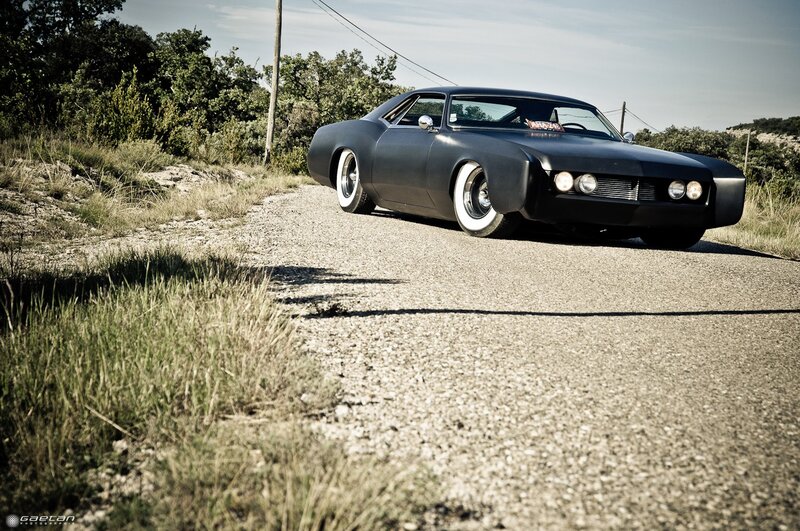 black classic car on gravel road