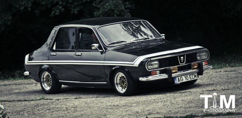 black classic car on gravel