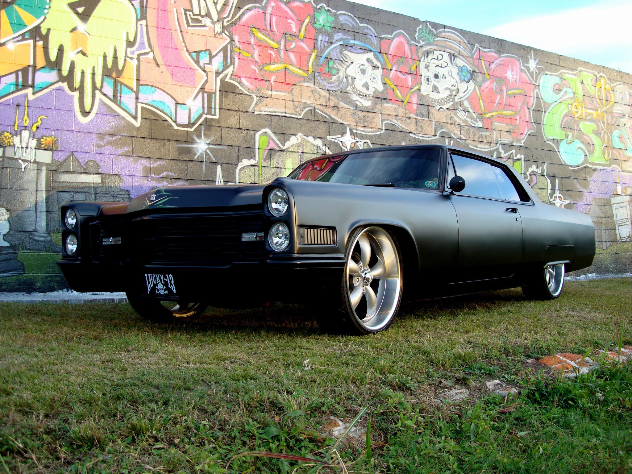 Black classic car with graffiti