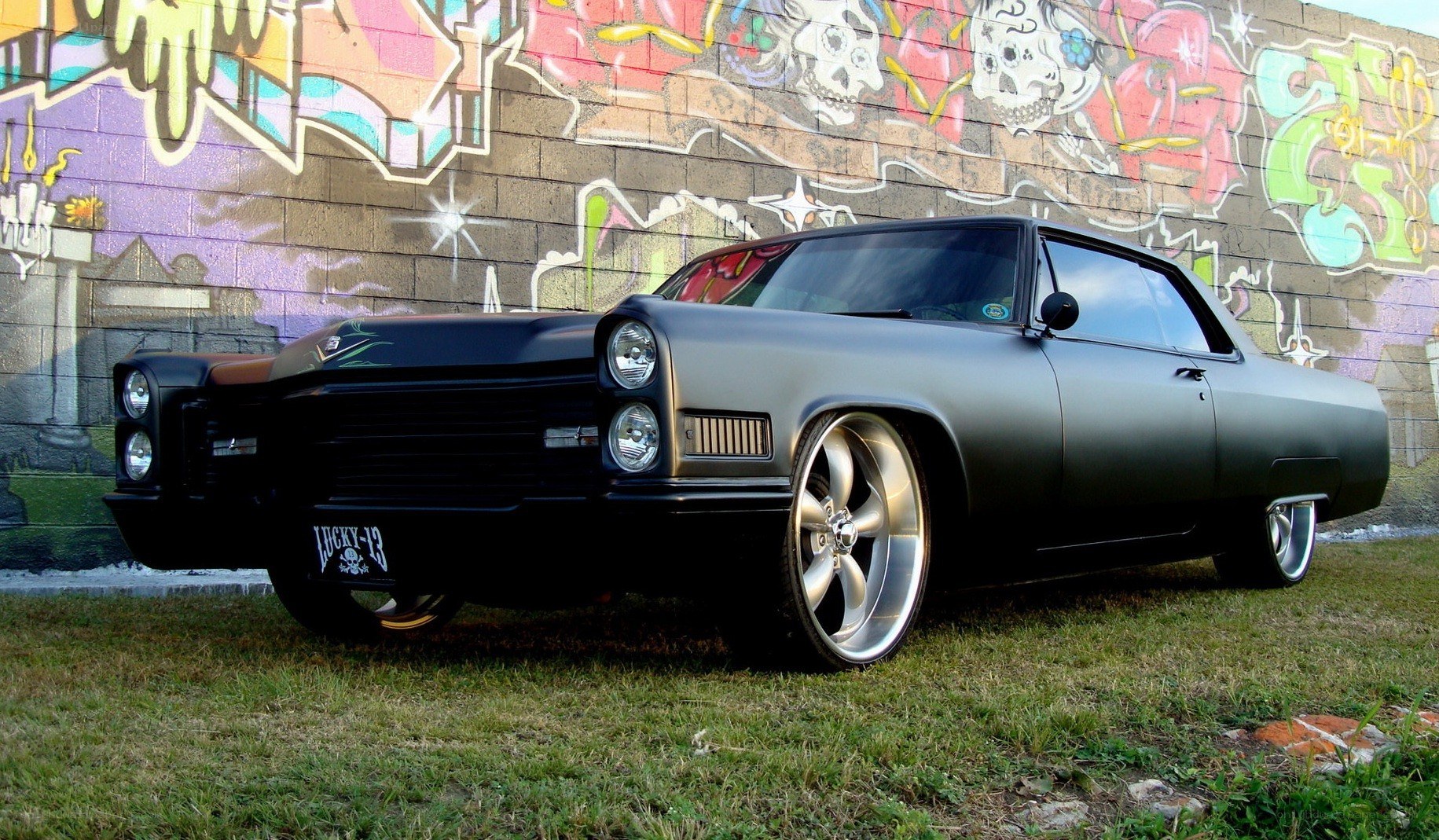 black classic car with graffiti