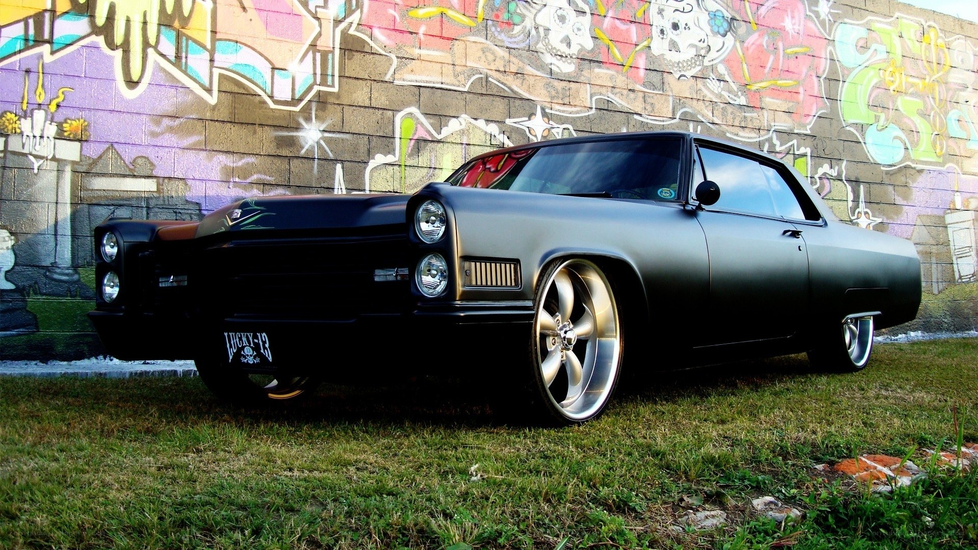 black classic car with graffiti