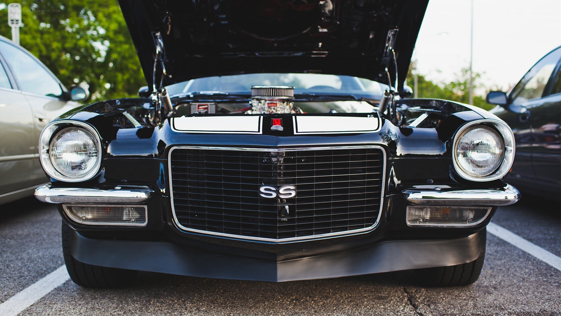 black classic car with open hood