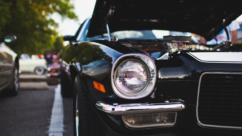 black classic car with open hood