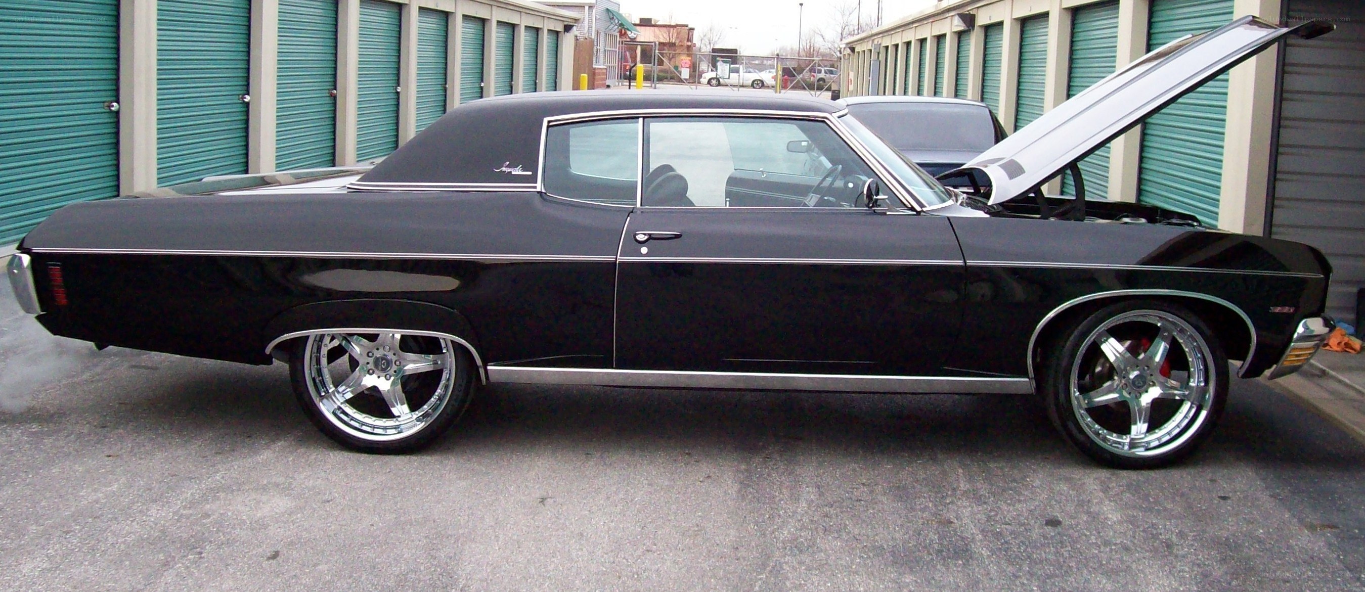 black classic car with open hood
