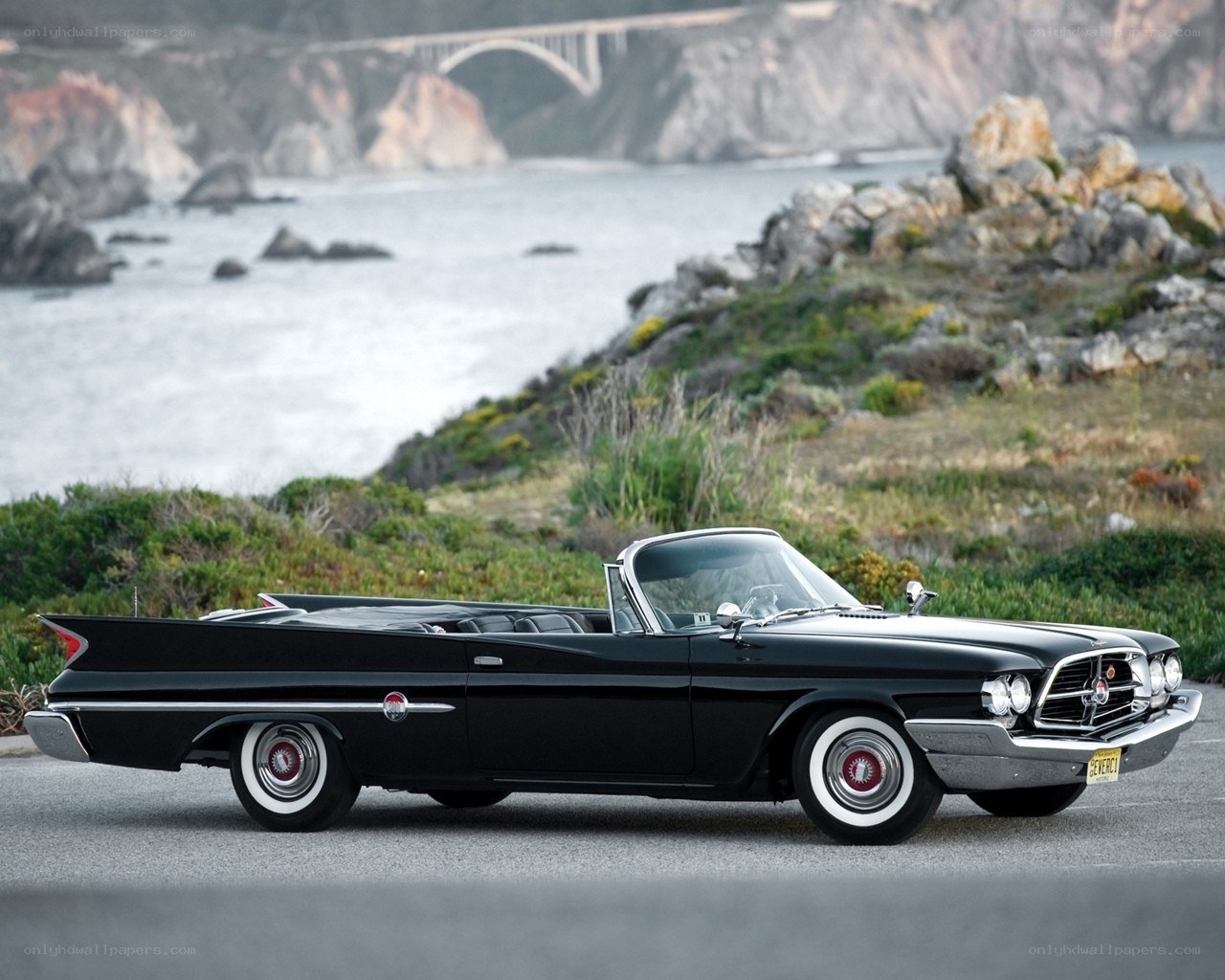 Black classic convertible by the coast
