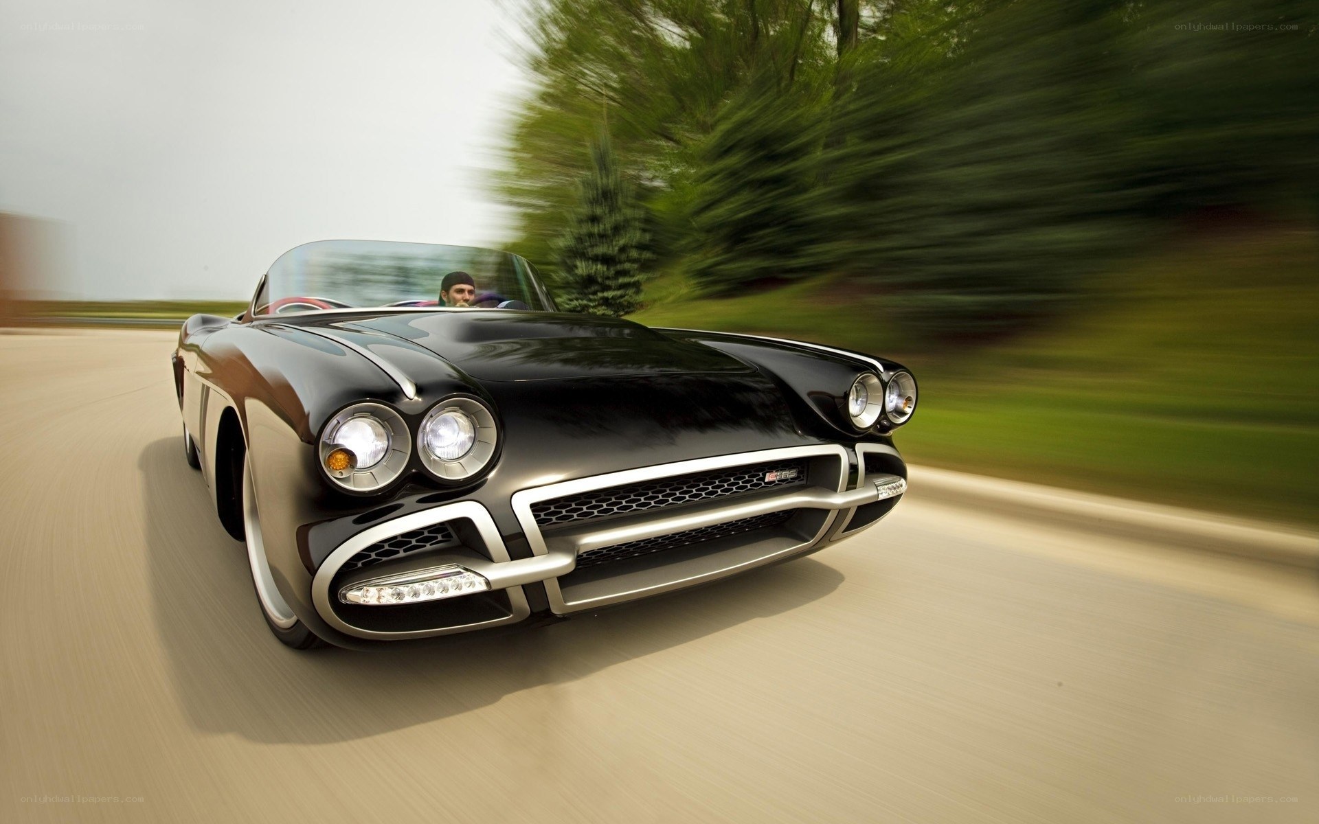 Black classic convertible in motion