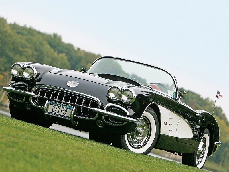 Black classic Corvette on grass
