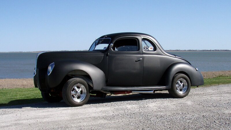 black classic coupe by water
