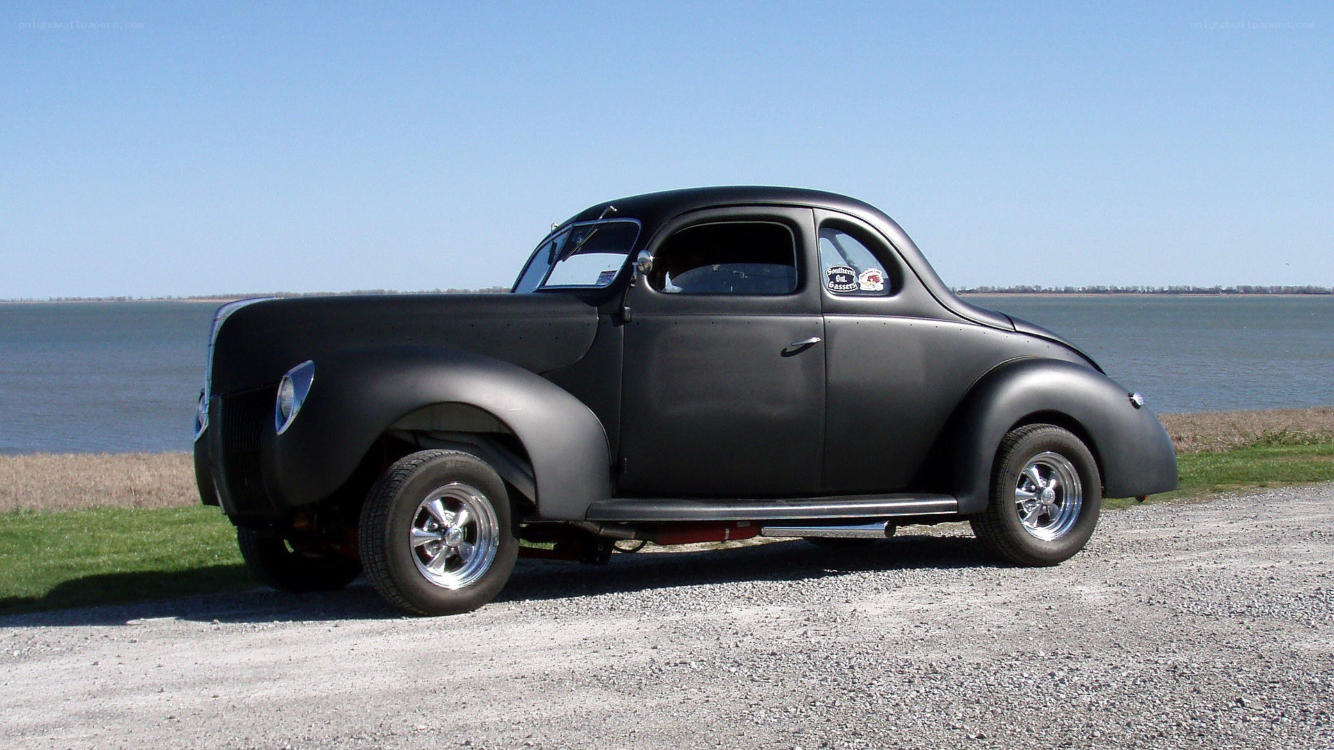black classic coupe by water
