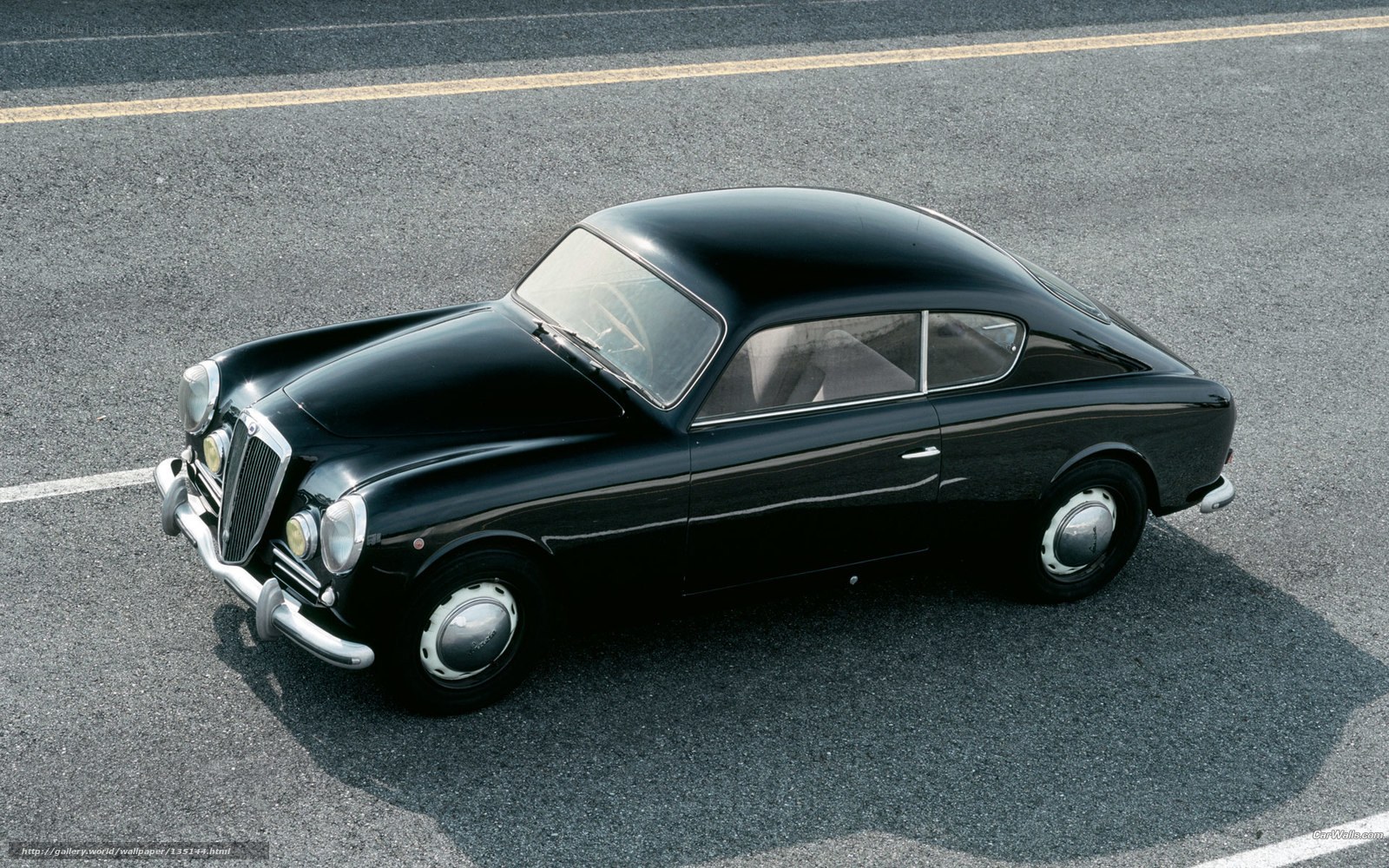 Black classic coupe on asphalt