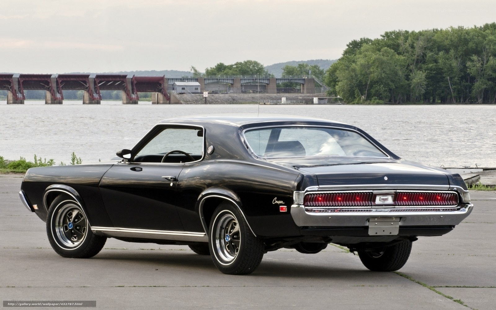Black classic muscle car by river