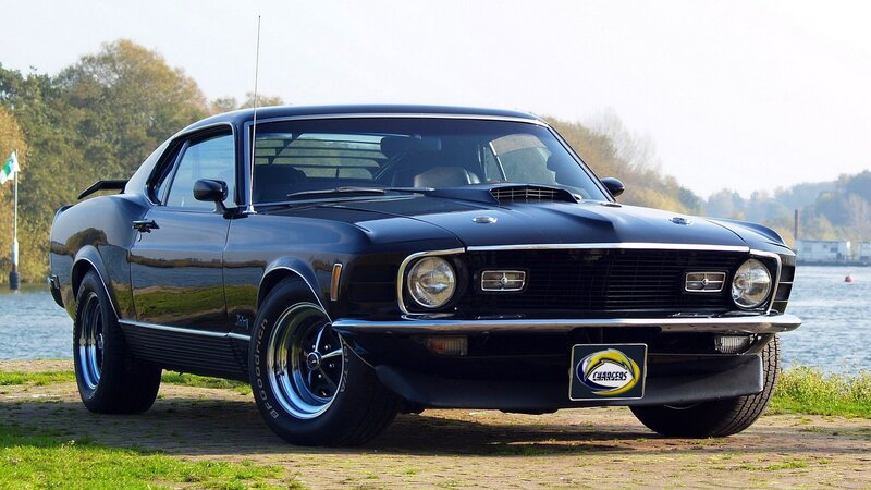 Black classic muscle car by water
