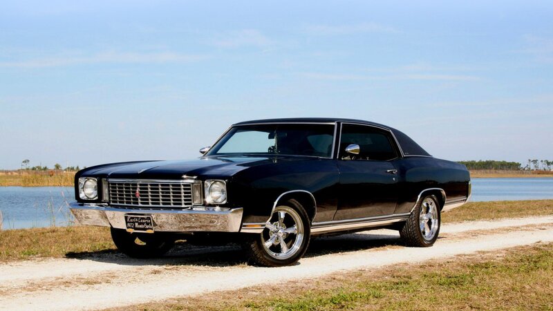 Black classic muscle car by water