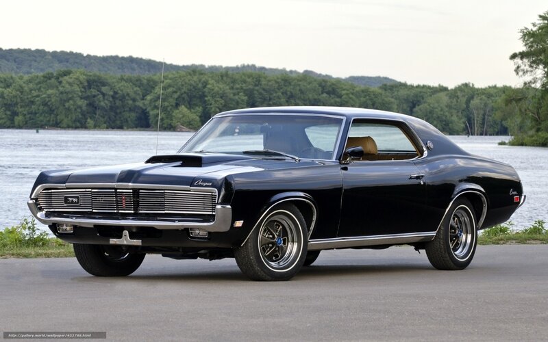 Black classic muscle car by water