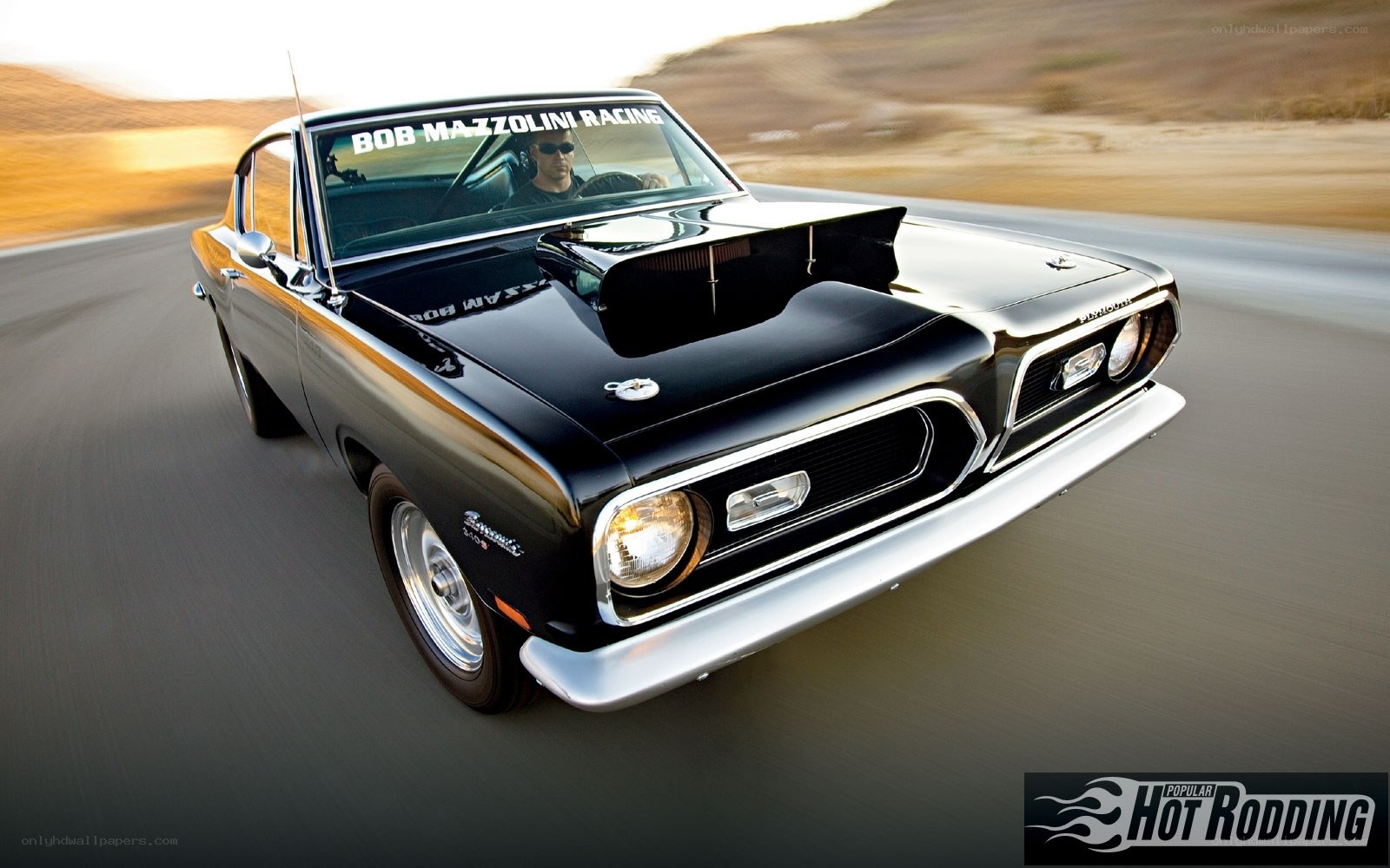 black classic muscle car in motion