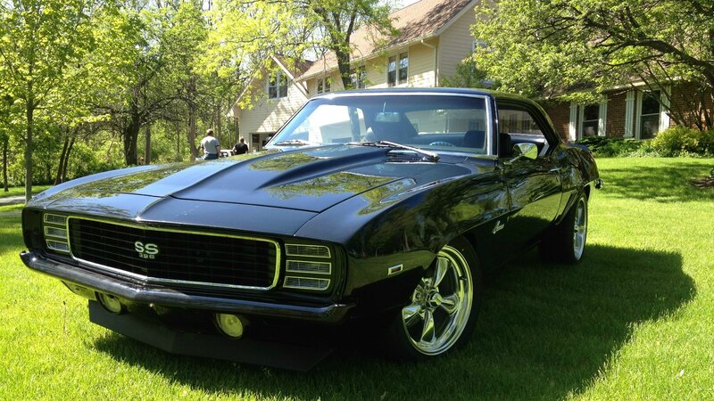 Black classic muscle car on lawn