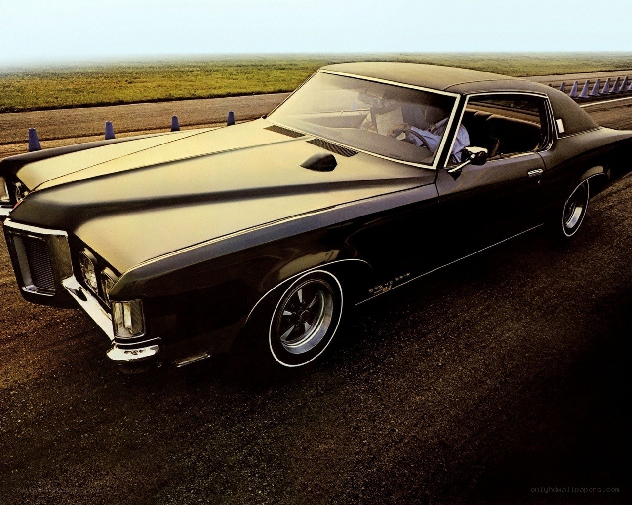 Black classic muscle car on track