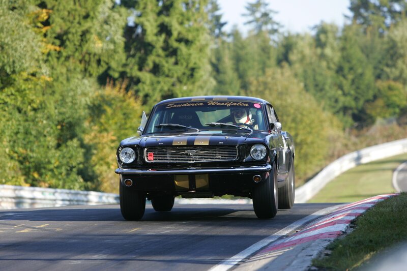 Black classic race car on track