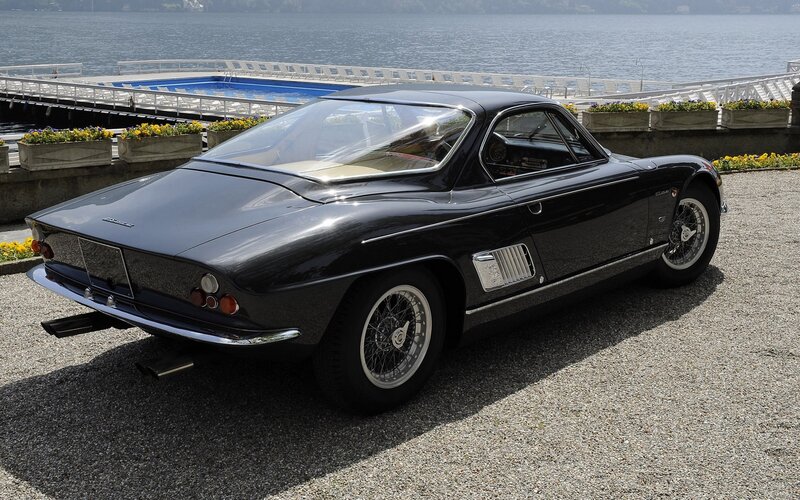 Black classic sports car by the lake