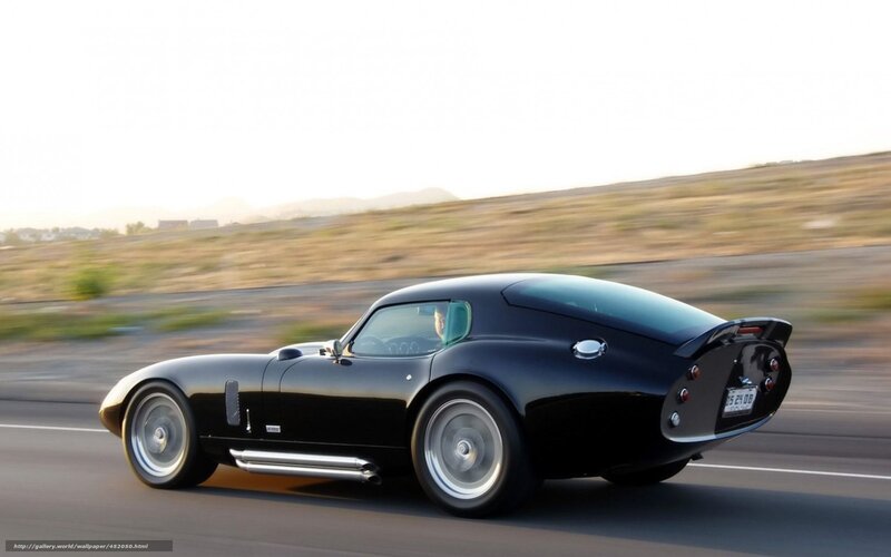 black classic sports car in motion