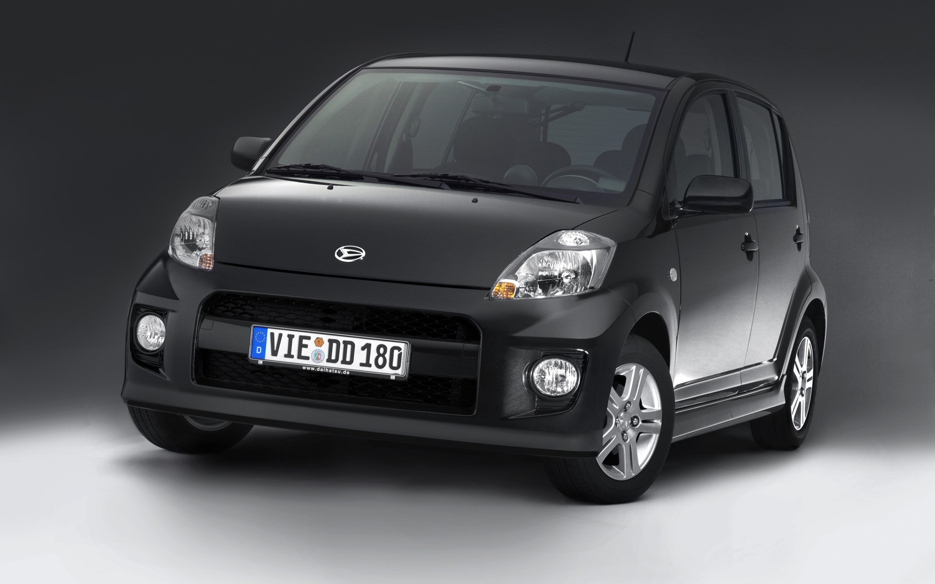 Black compact car in studio