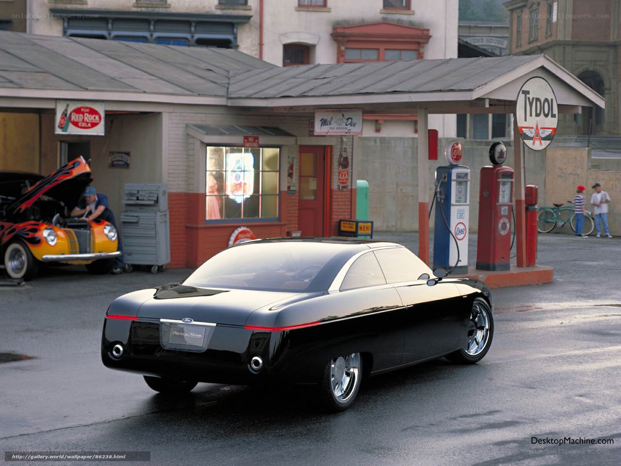 Black concept car at gas station