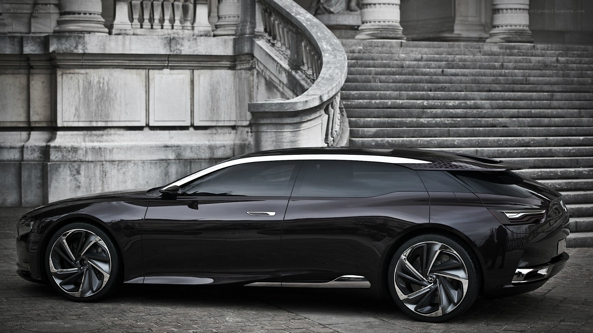 black concept car on cobblestones