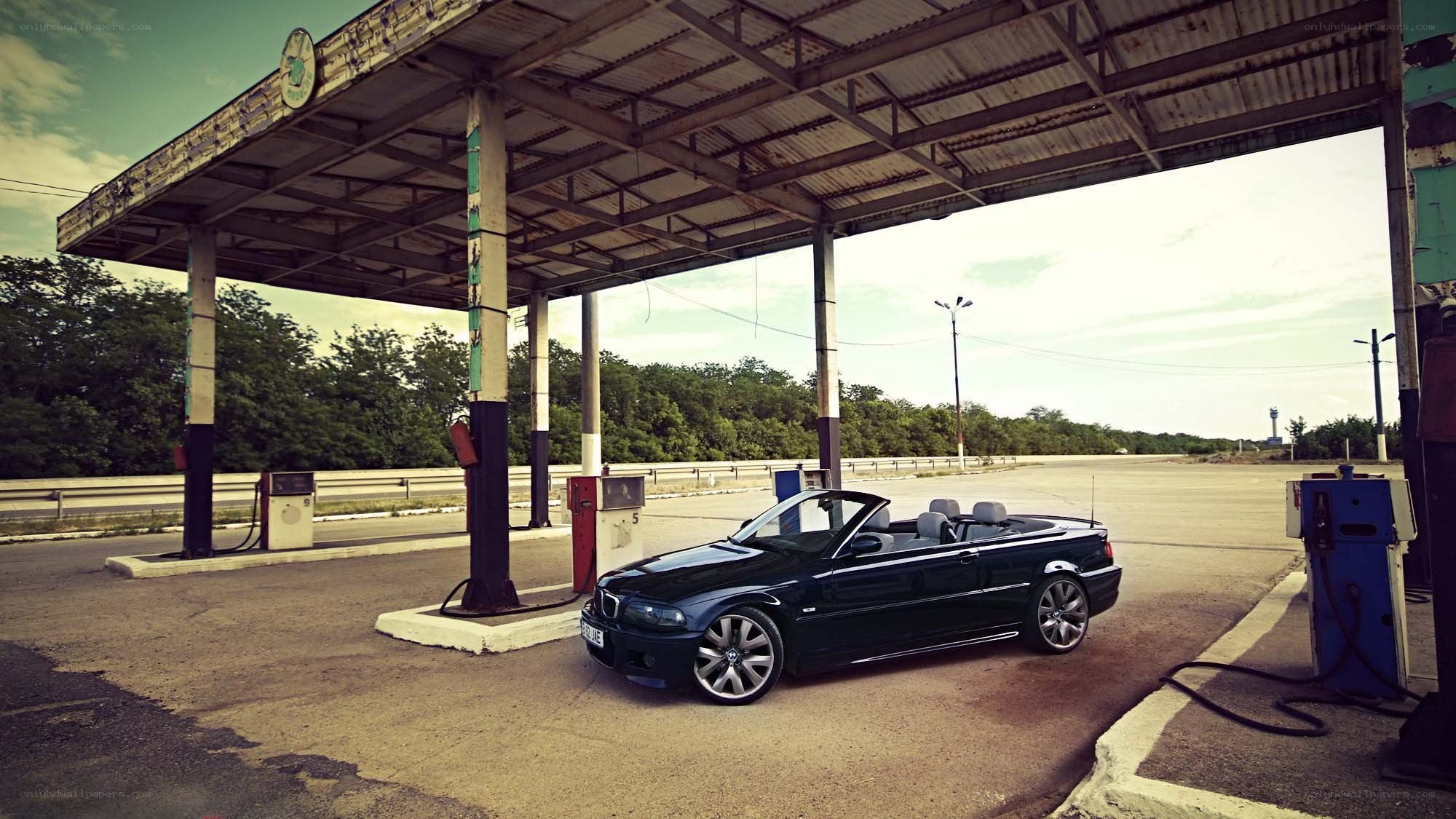 Black convertible at gas station