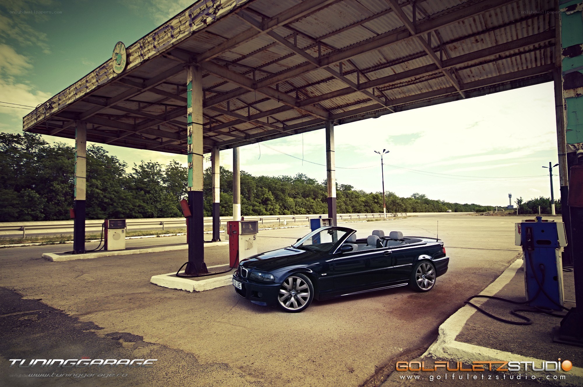 Black convertible at gas station