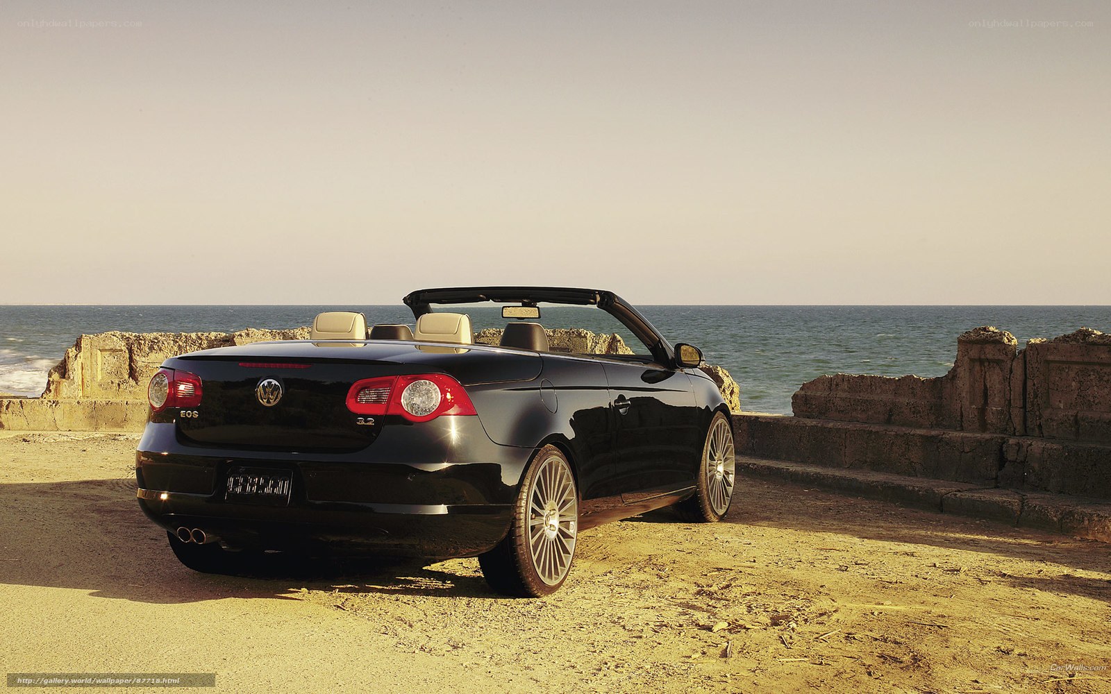 Black convertible by the sea