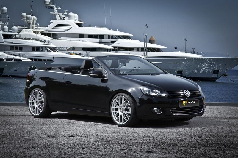 Black convertible car at marina