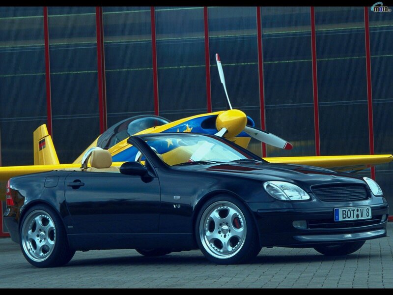 Black convertible car with airplane