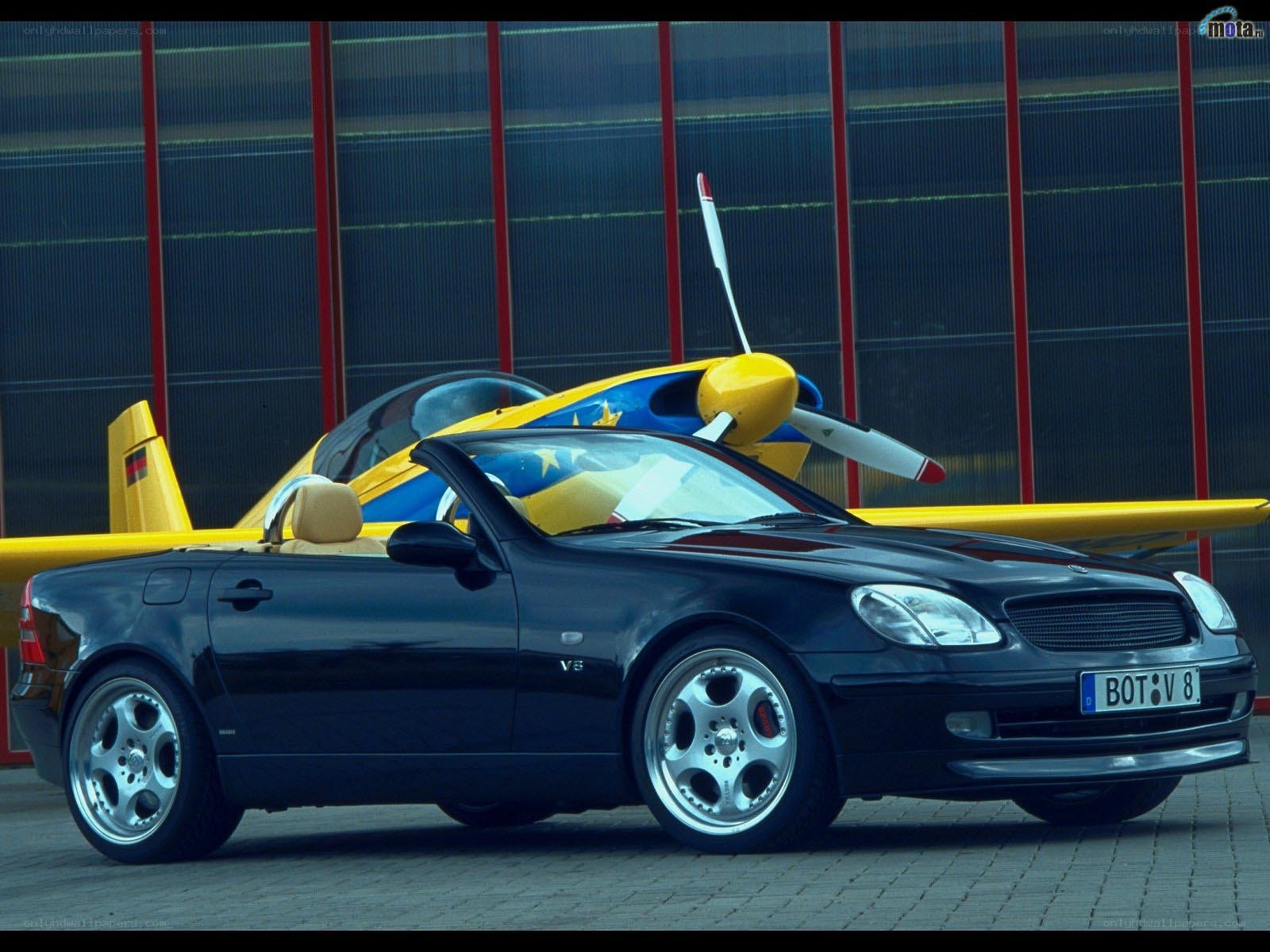 Black convertible car with airplane