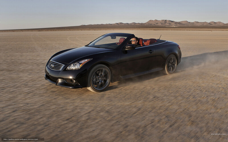 Black convertible driving in desert
