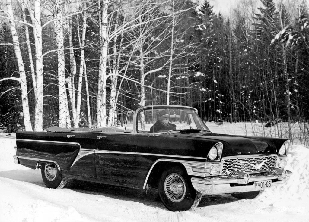Black convertible in snowy forest