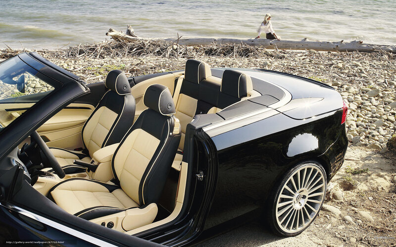 Black convertible on a pebble beach