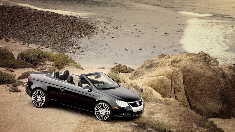 Black convertible on beach