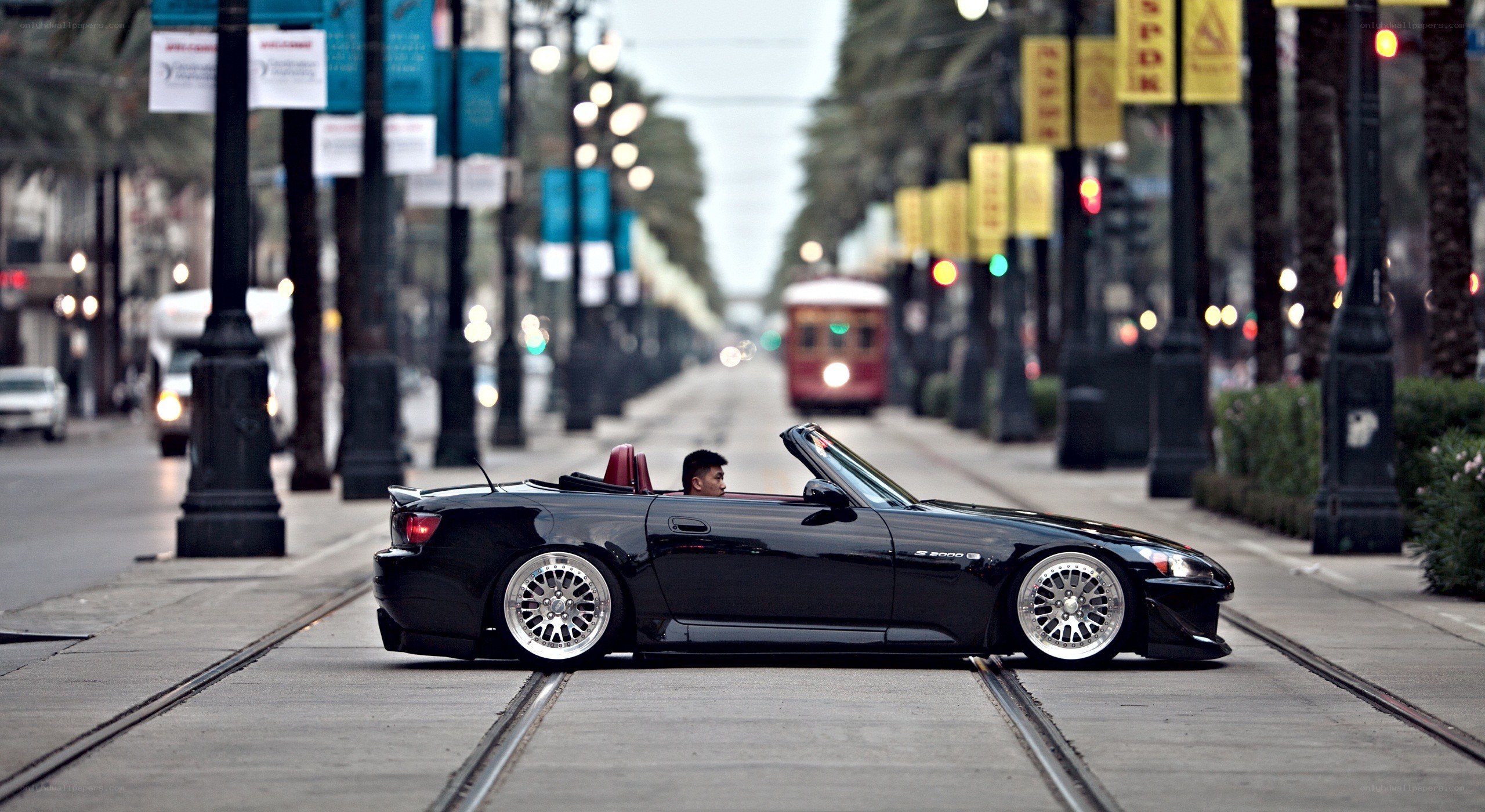 Black convertible on city street