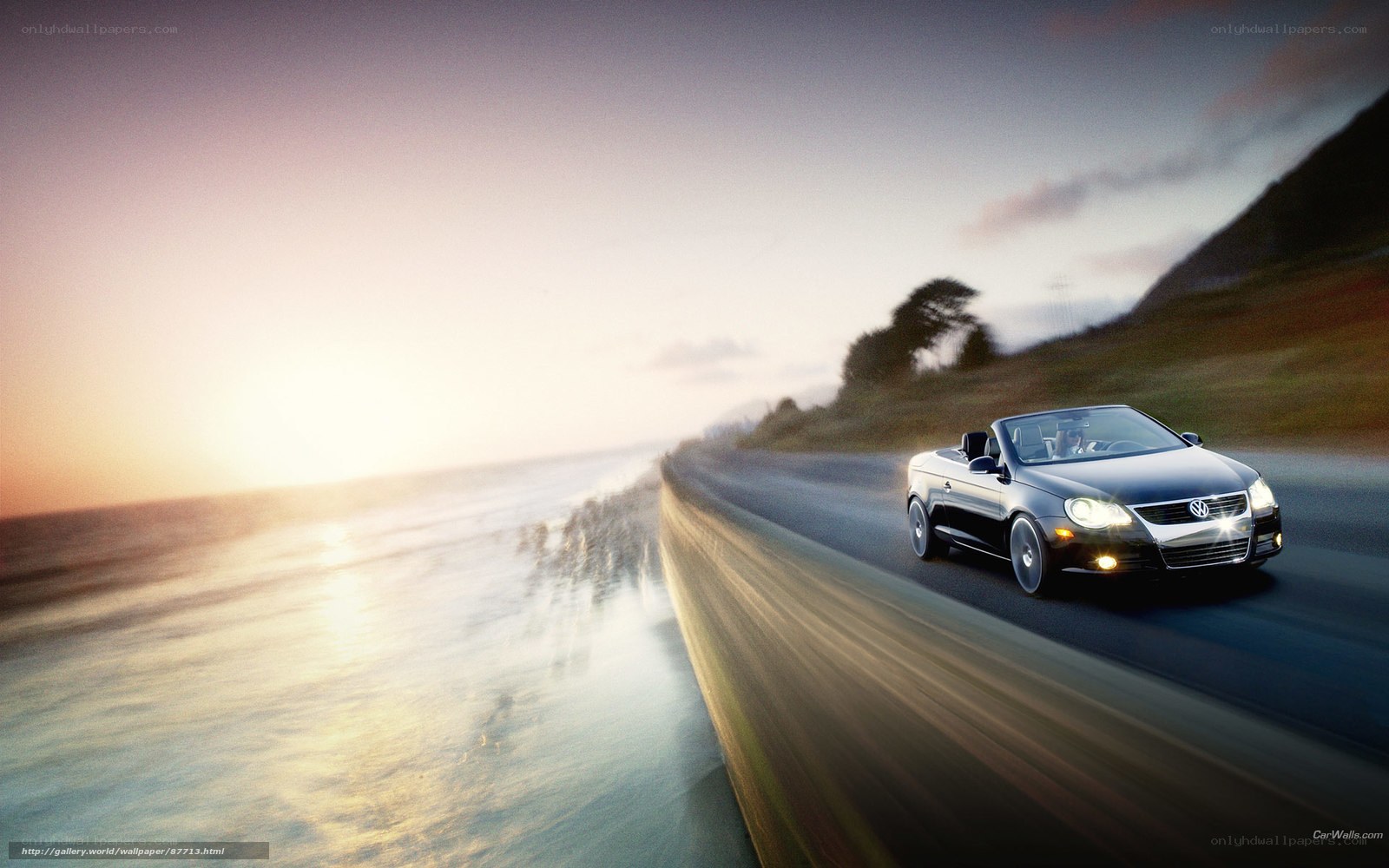 Black convertible on coastal road
